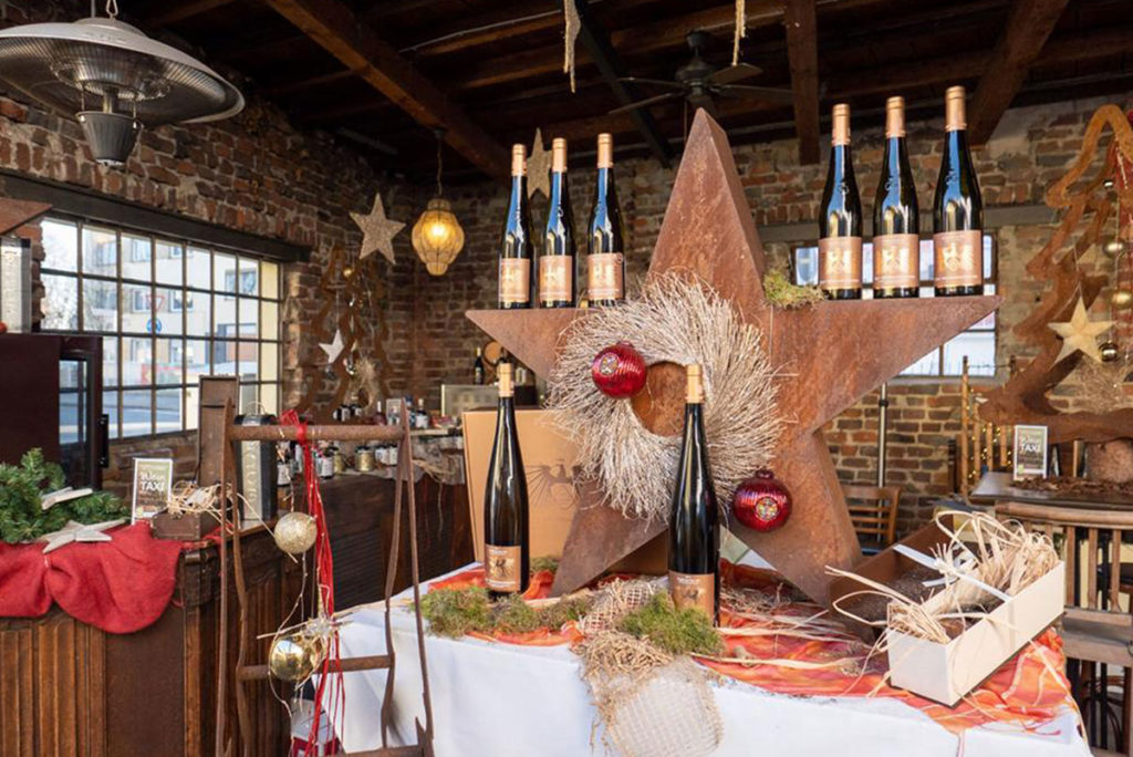 Weinflaschen auf einem weihnachtlich geschmückten Tisch in der Weinschmiede Siegburg